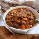 A bowl of chili with a spoon.