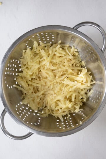 Grated potatoes in a colander