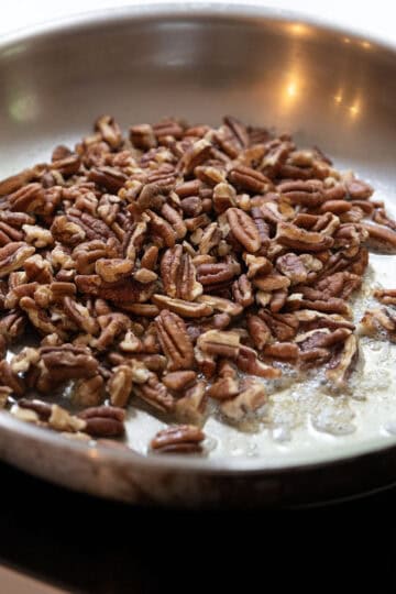 Pecans toasting in a saucepan.