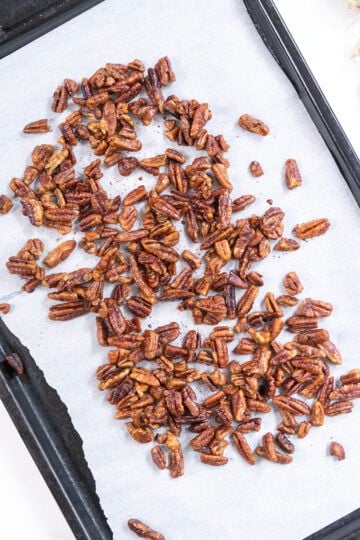 Pecans roasted on baking tray.