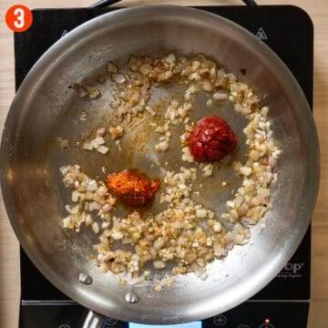 Caramelizing tomato paste and Calabrian chili peppers in a saucepan.