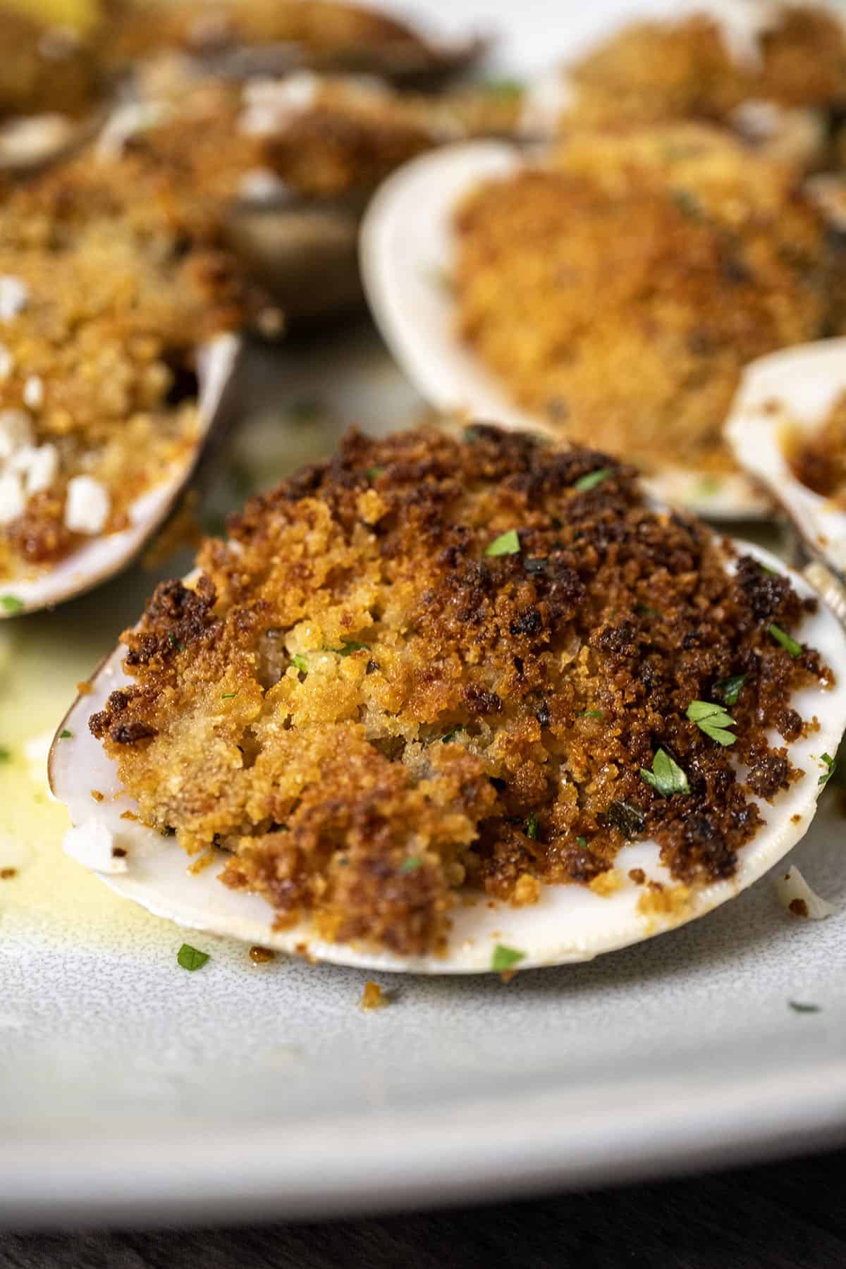 Single baked clam on a plate. 