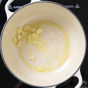 Garlic sauteing in a dutch oven. 