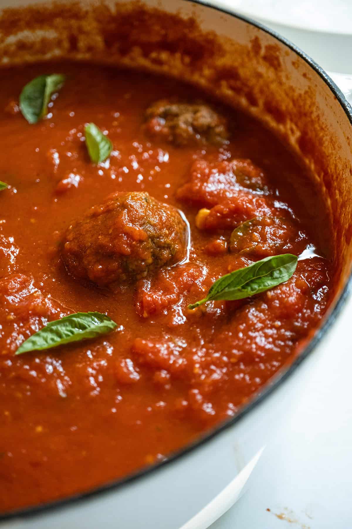 Sunday sauce with meatballs and sausage in a pot.