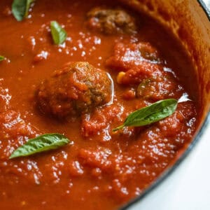 Sunday sauce with meatballs and sausage in a pot.