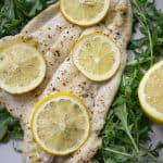 broiled lemon garlic flounder over arugula and topped with lemon slices