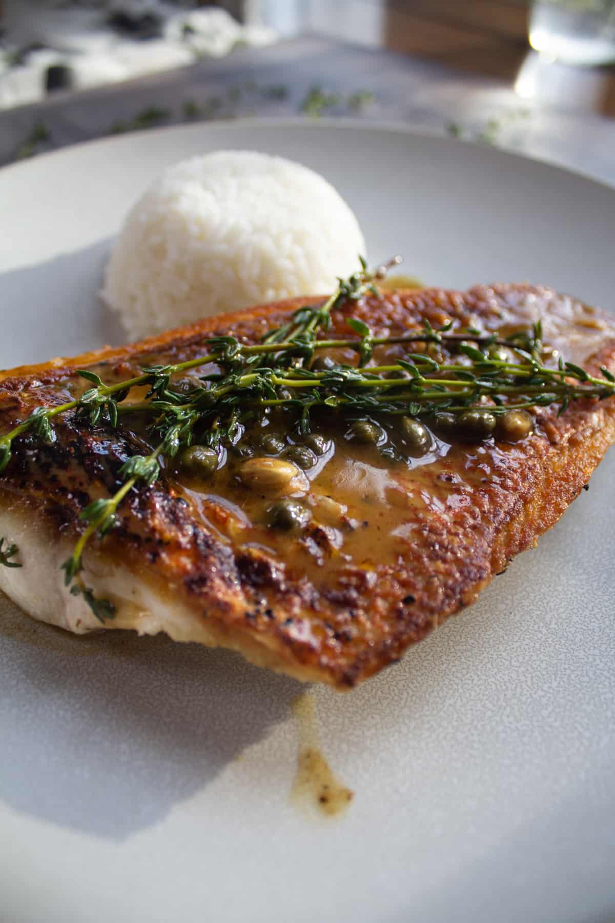 snapper topped with thyme and capers with rice pilaf