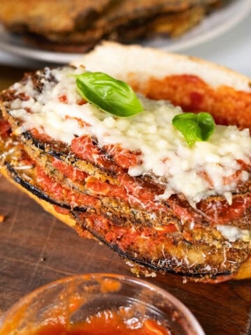 Eggplant topped with marinara, parmesan, and mozzarella on a roll.