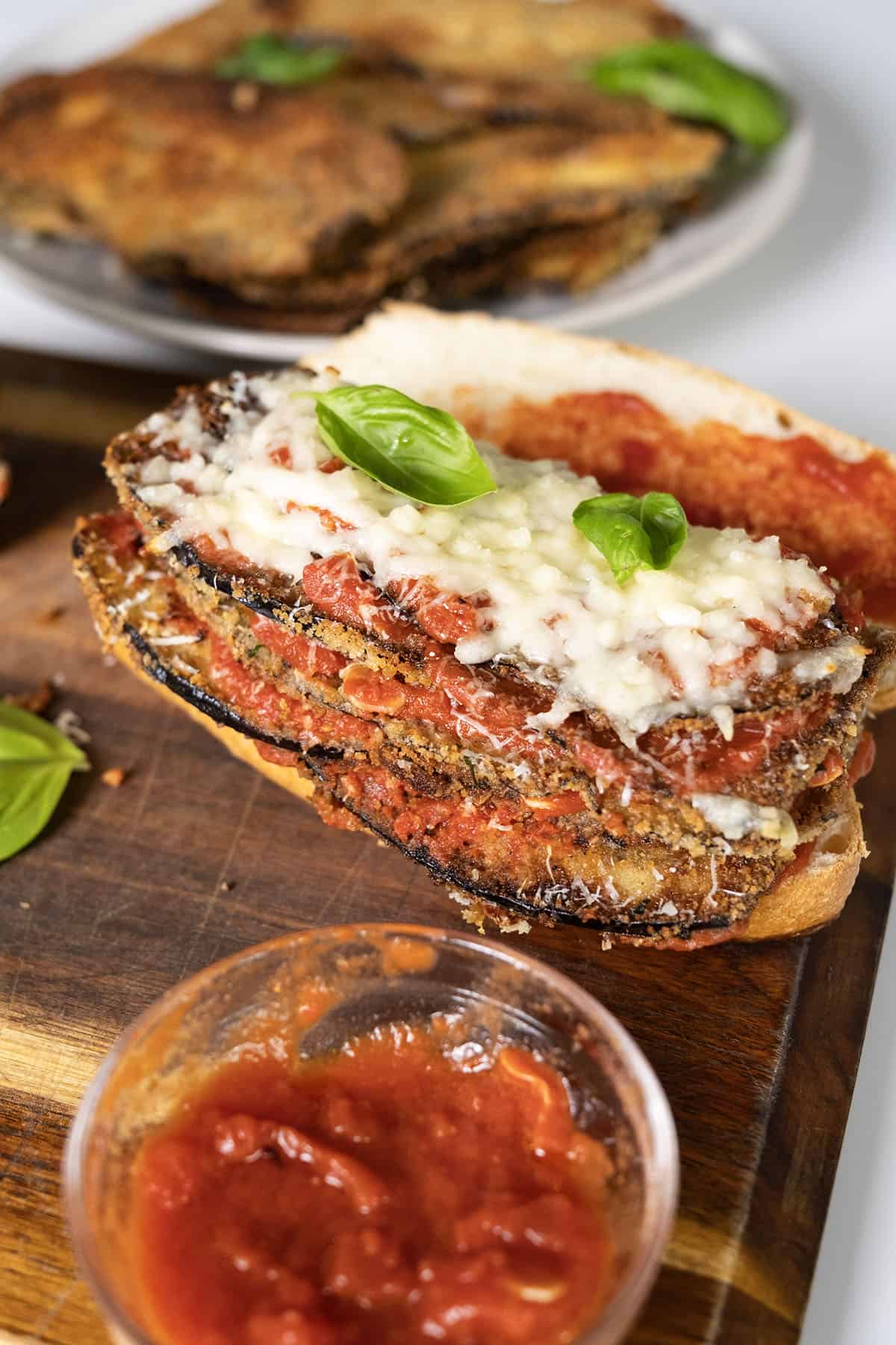 Eggplant topped with marinara, parmesan, and mozzarella on a roll.