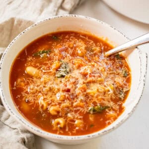 Pasta fagiolo topped with parmesan in a bowl.