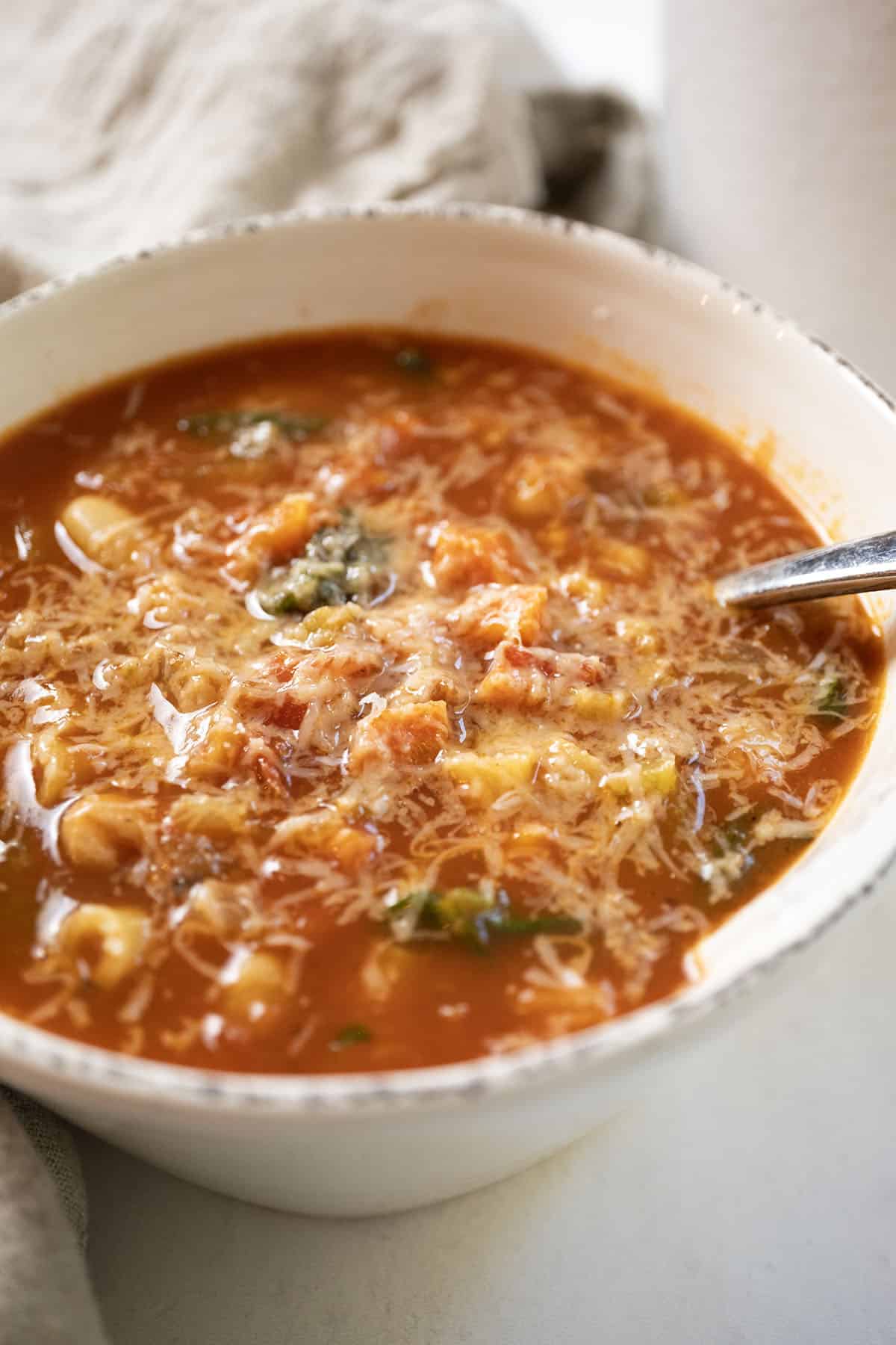 Pasta fagiolo topped with parmesan in a bowl.