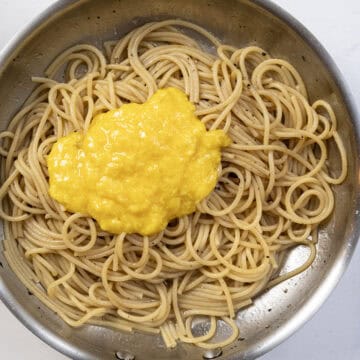 Egg and cheese mixture added to the pasta.