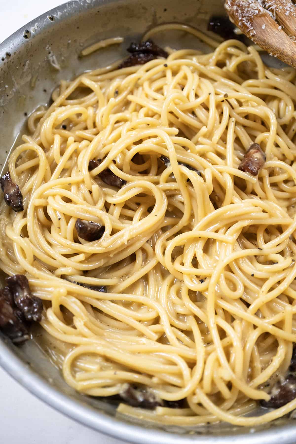 Spaghetti Carbonara beginning to get creamy in the pan.