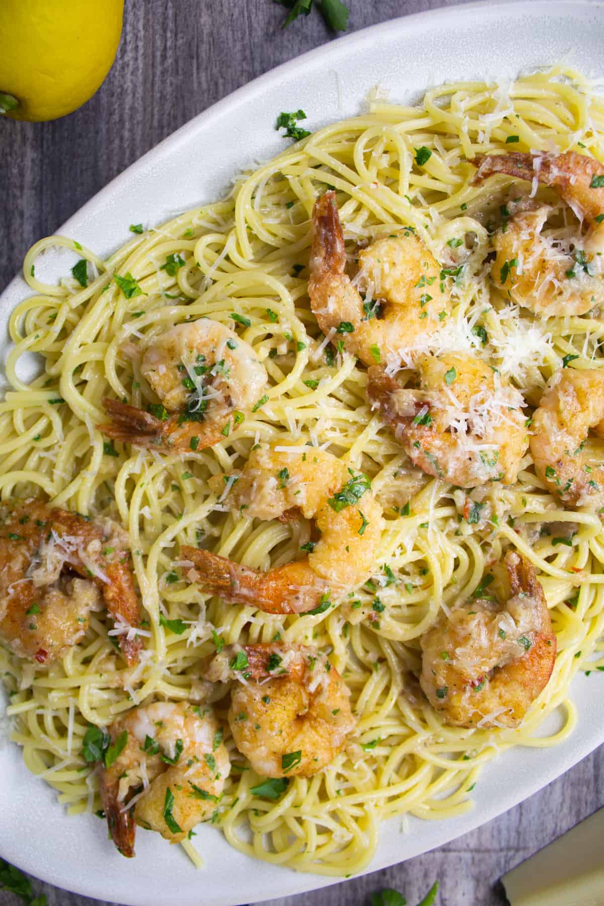 shrimp scampi over spaghetti garnished with parsley