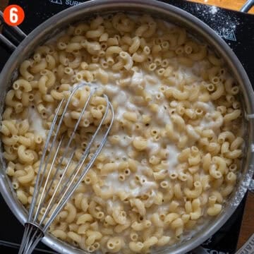 Combining the macaroni with the cheese mixture.