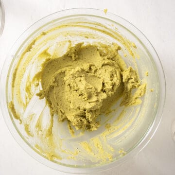 Pistachio butter, sugar, and mascarpone combined in a bowl.