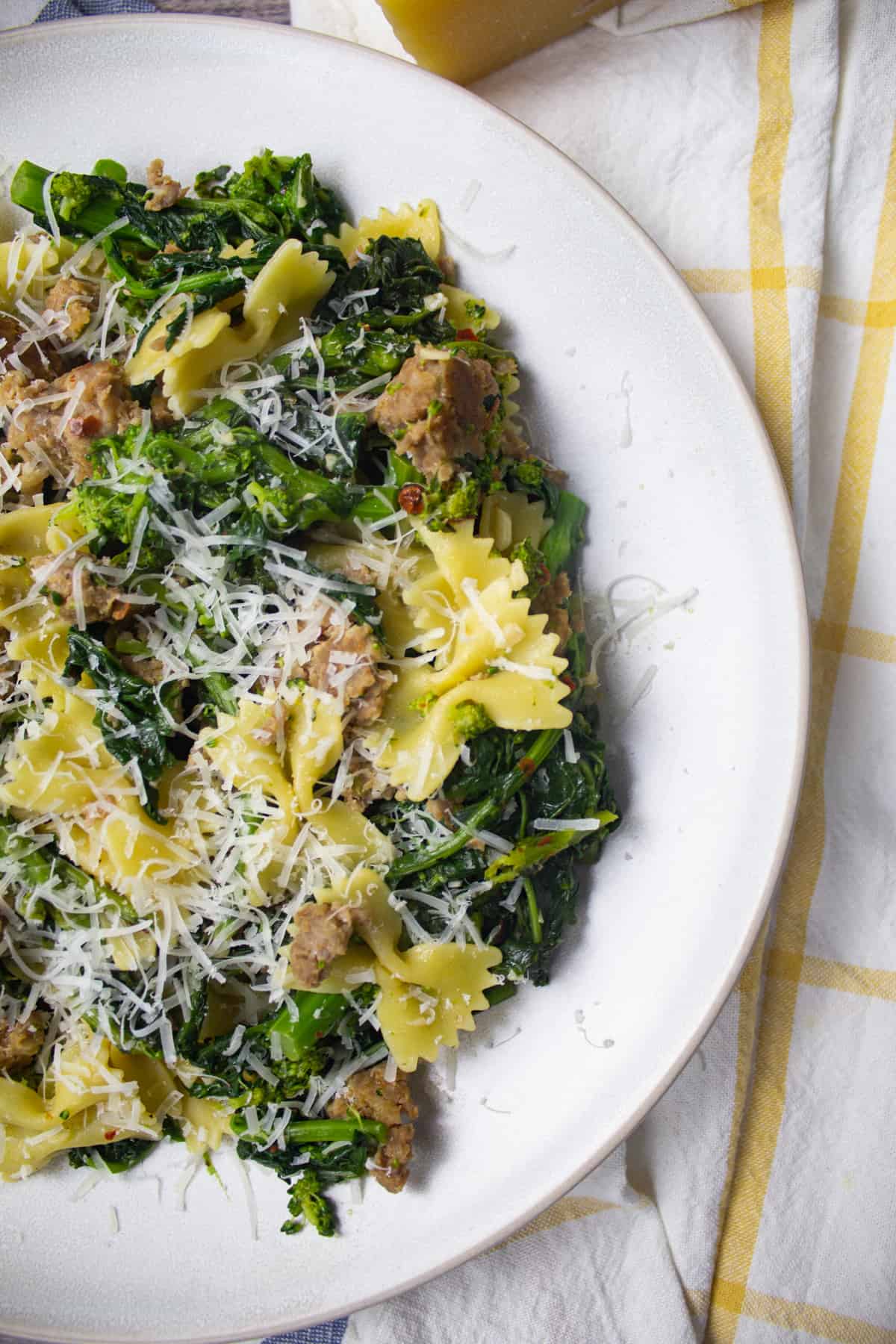 farfalle with sausage and broccoli rabe topped with parmesan cheese