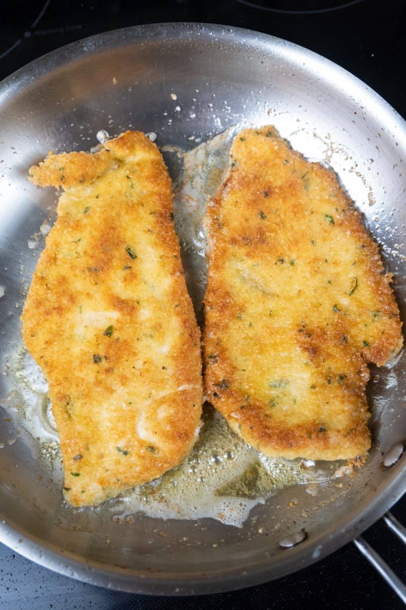 chicken cutlets frying in EVOO