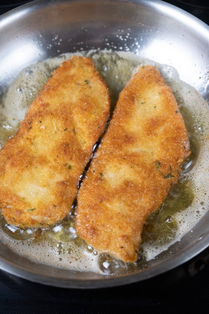 chicken cutlets frying in avocado oil