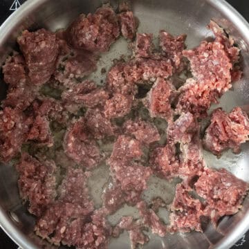 Lamb searing in saucepan. 