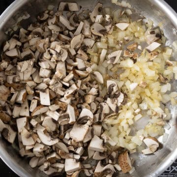 Onions and mushrooms sauteing in sauce pan.