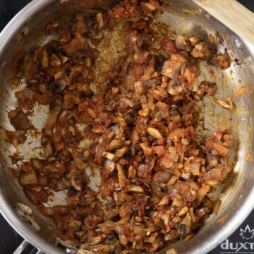 Tomato paste added to vegetables in saucepan.