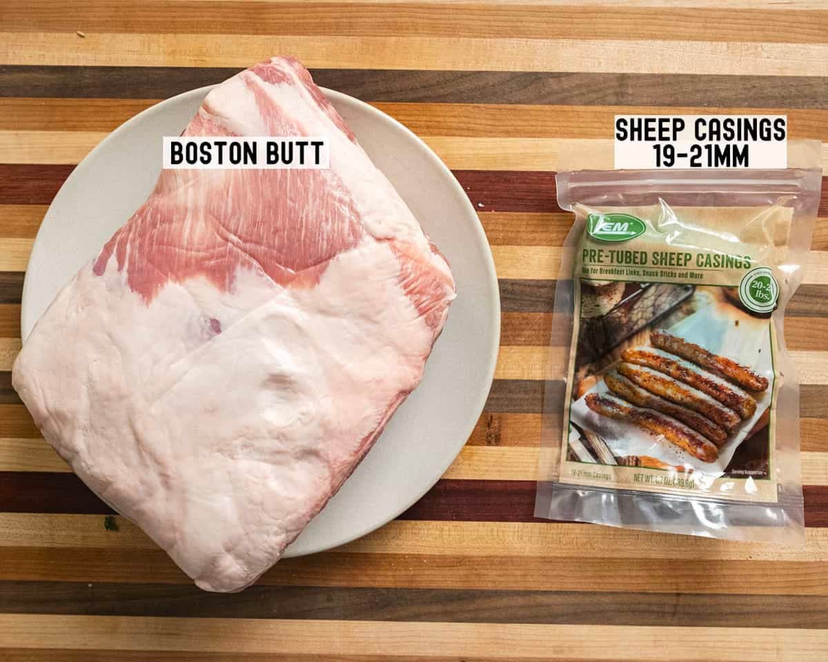 Pork butt and casings on a cutting board.