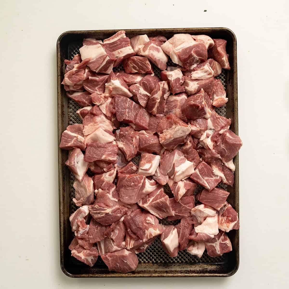 Cut pork shoulder in 1-2 inch pieces.