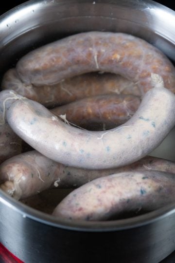 Sausages in pot of water to be boiled