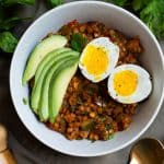 eggs and lentils for breakfast with sliced avocado