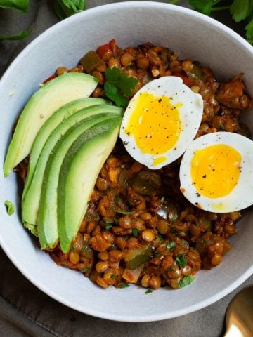 eggs and lentils for breakfast with sliced avocado