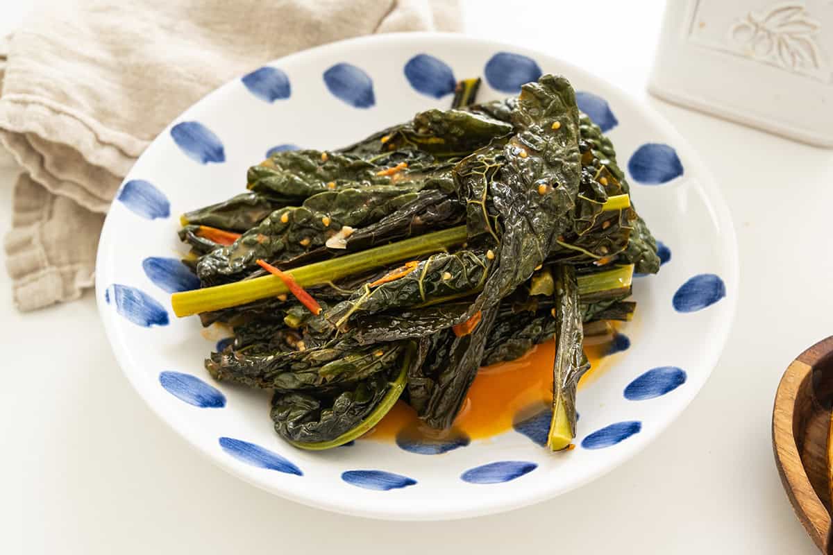 Italian Braised lacinato kale with cherry tomatoes in a bowl.