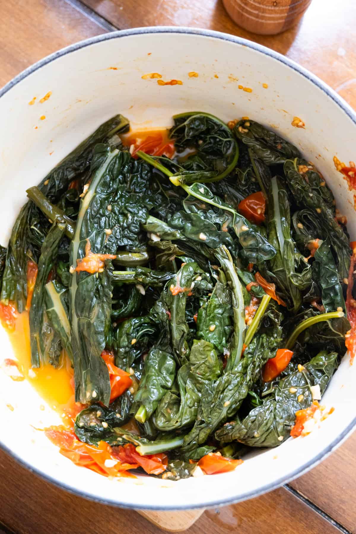 lacinato kale shown braised in dutch oven with cherry tomato juices