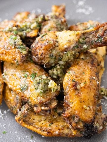 air fryer garlic parm wings piled neatly on a plate