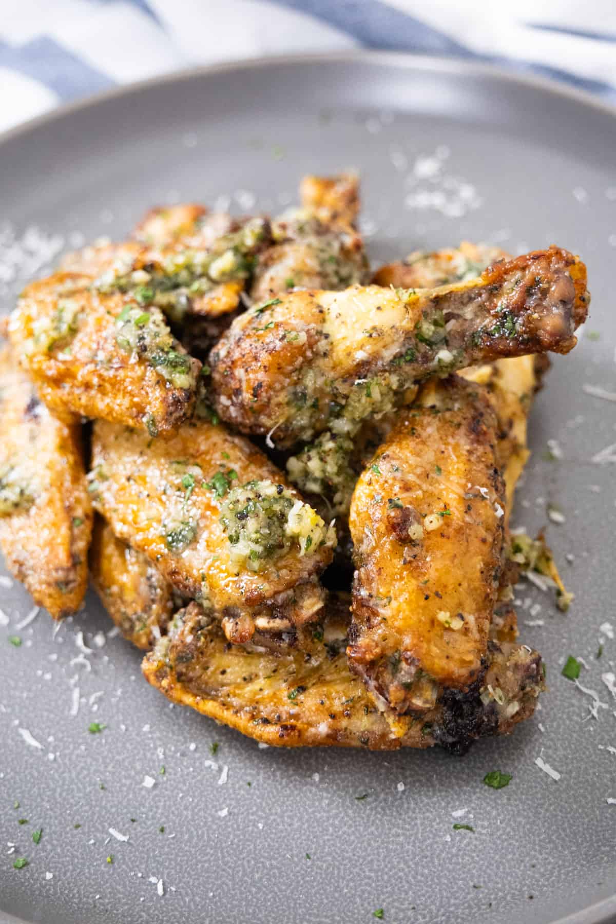 air fryer garlic parm wings garnished with parsley