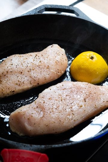 chicken raw in cast iron with lemon