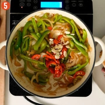 Sauteing peppers and onions with cherry peppers and garlic.