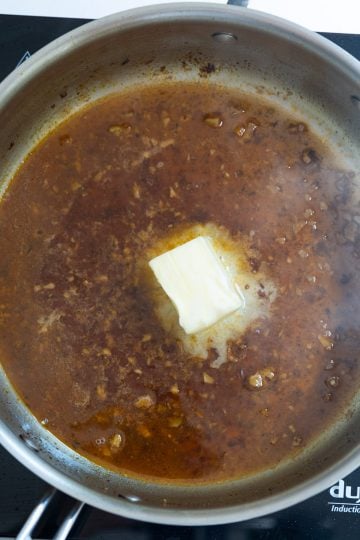 butter added to simmering garlic wine sauce