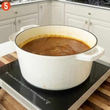 Chicken stock added to the soup to simmer.