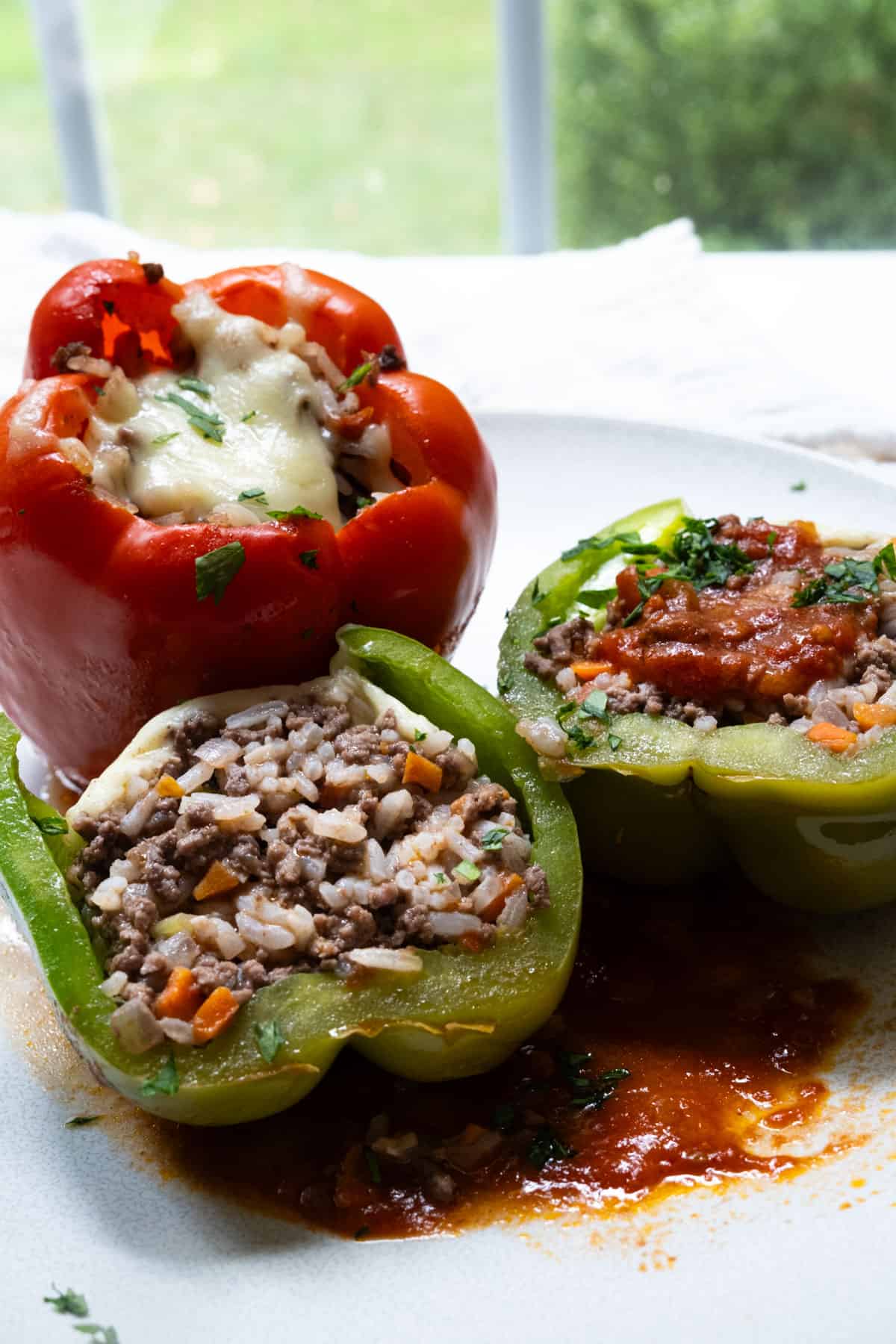 italian stuffed peppers topped with mozzarella and tomato sauce