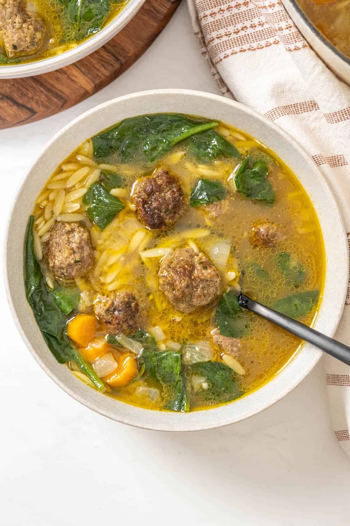 italian wedding soup in a bowl with meatballs