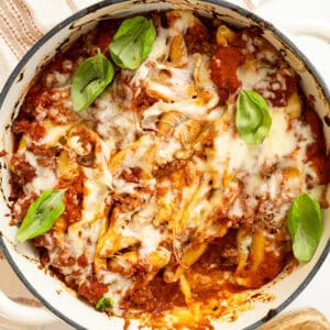 Italian stuffed shells with melted mozzarella in a dish.