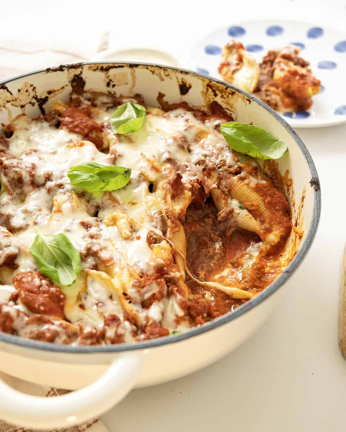 Italian stuffed shells with melted mozzarella in a dish.