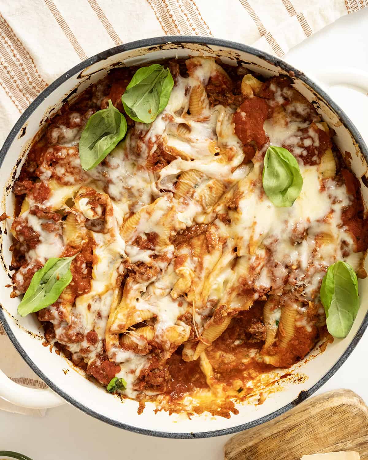 Italian stuffed shells with melted mozzarella in a dish.