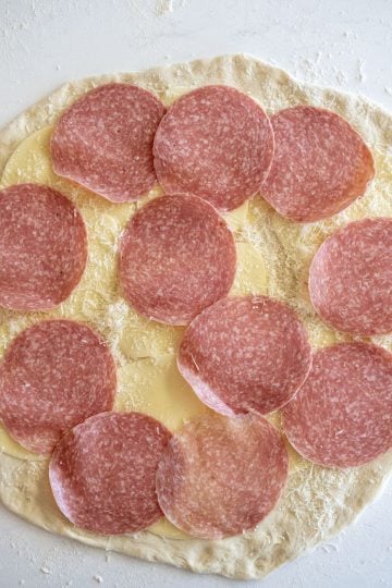 Layer of salami added to the dough