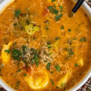 rustic italian tortellini soup topped with parmesan