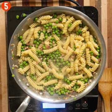 Peas and pasta added to the pan.