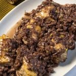 Chicken thighs covered in red wine and fennel sauce