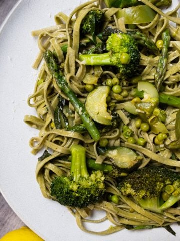 pasta primavera plated with broccoli and zucchini