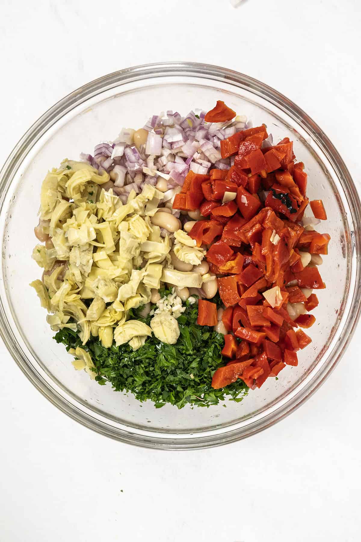 Vibrant Summer Farro & Cannellini Bean Salad 5 Roasted red pepper and artichoke hearts, finely chopped, ready to be added to the salad.